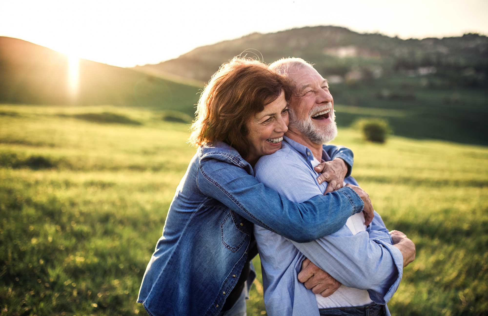 retiree couple embrace 